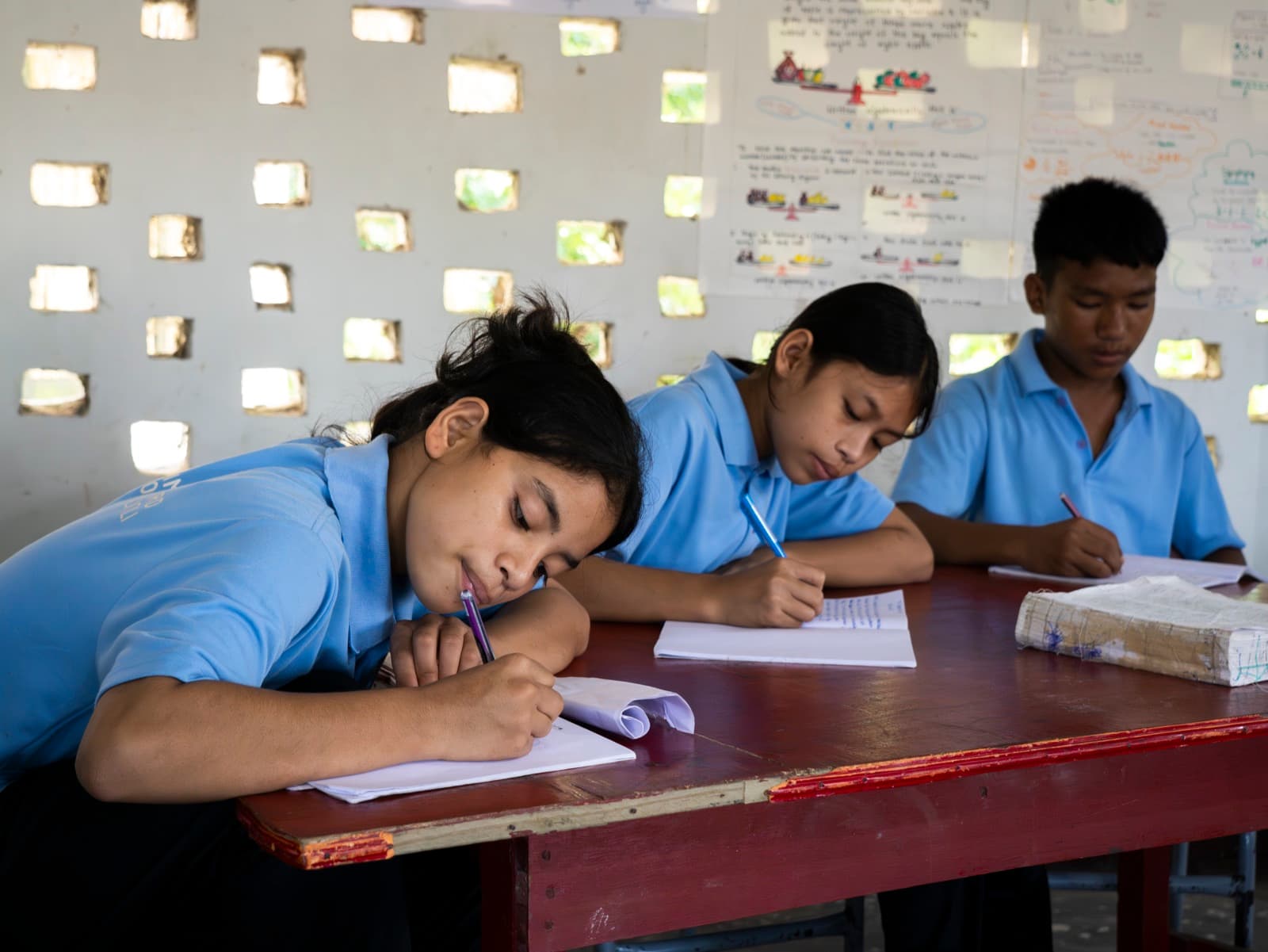 Hummingbird students concentrating on their notebooks in class