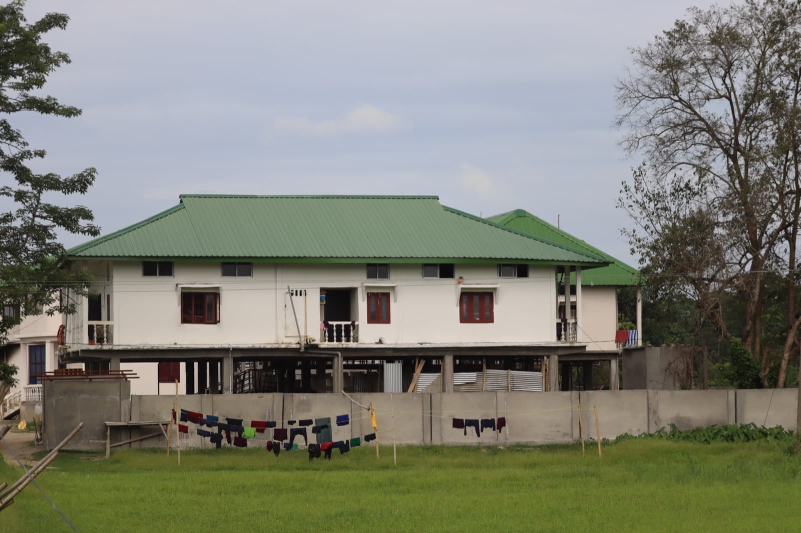The Hummingbird Home, the residential building on stilts, with laundry on the line