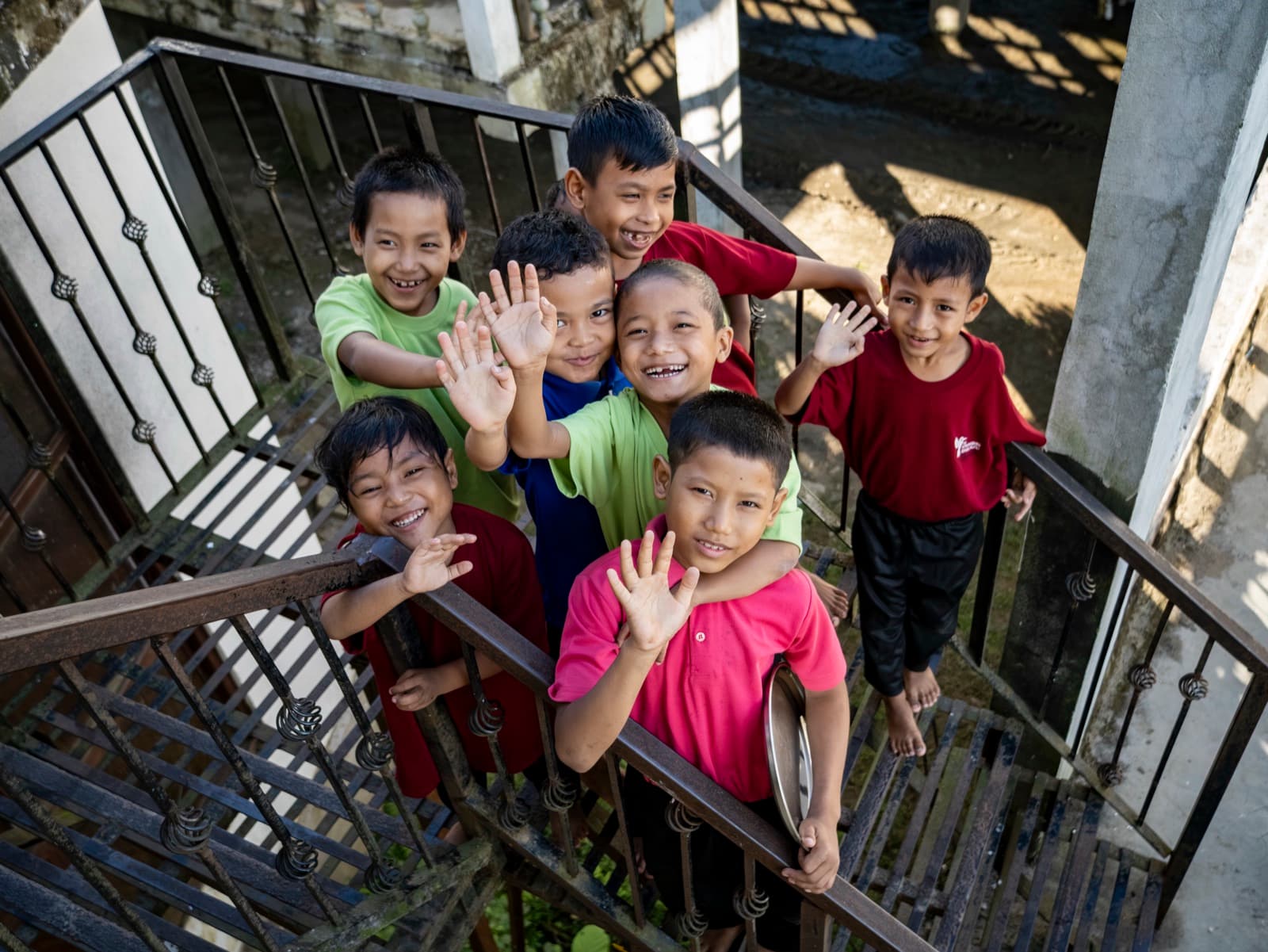 Children at the Home, waving from the stairwell